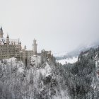 Surreal image of European-style building unfolding on cliff and flat surface under cloudy sky