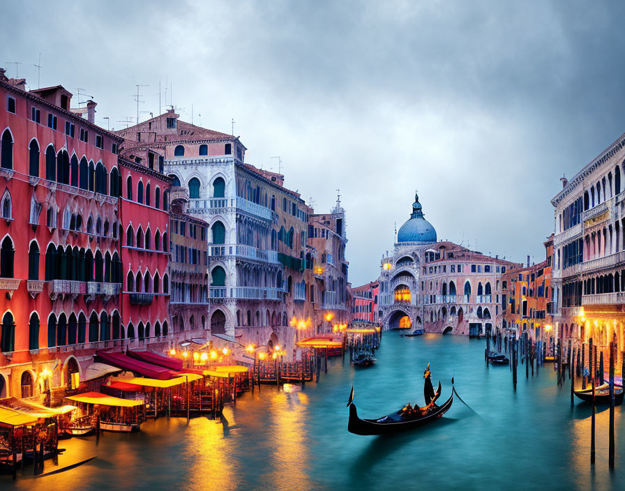 Historic buildings, gondola, and Santa Maria della Salute at dusk