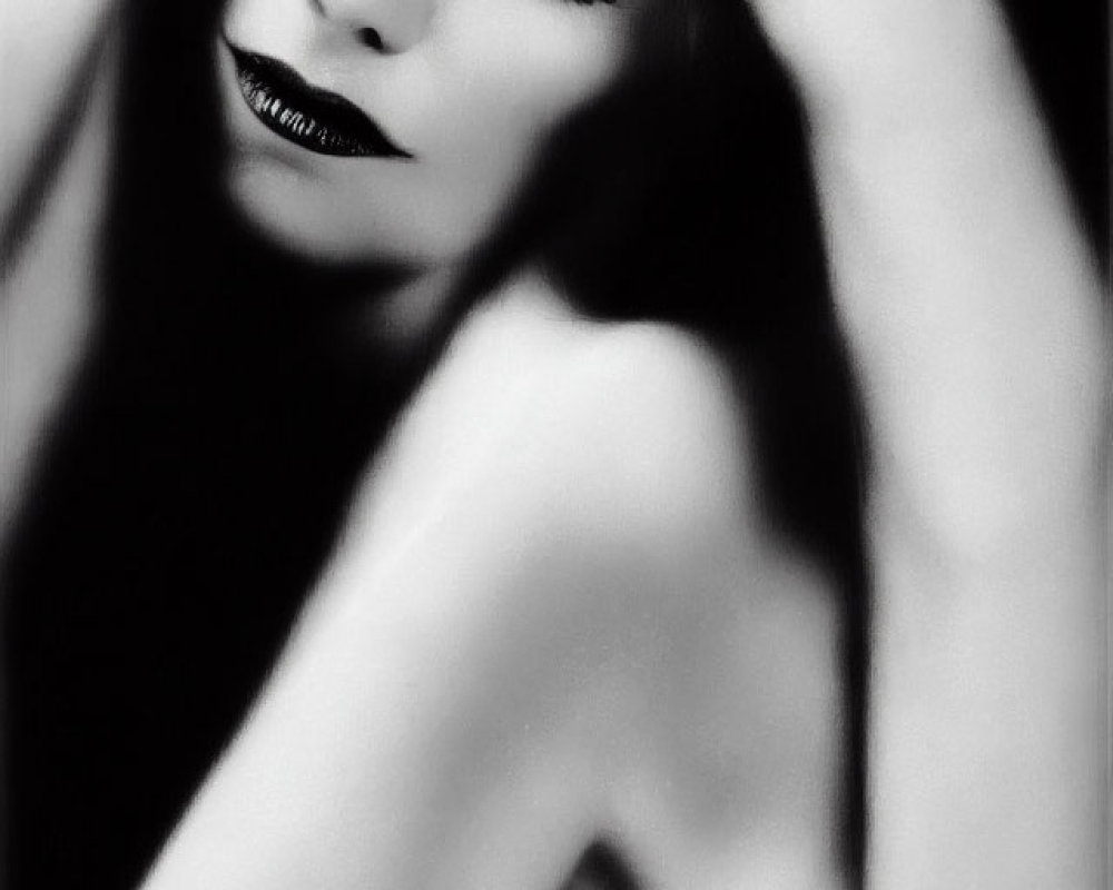 Monochrome portrait of woman with striking makeup and hand on head