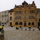 Medieval village scene with townsfolk in period attire and cobblestone streets