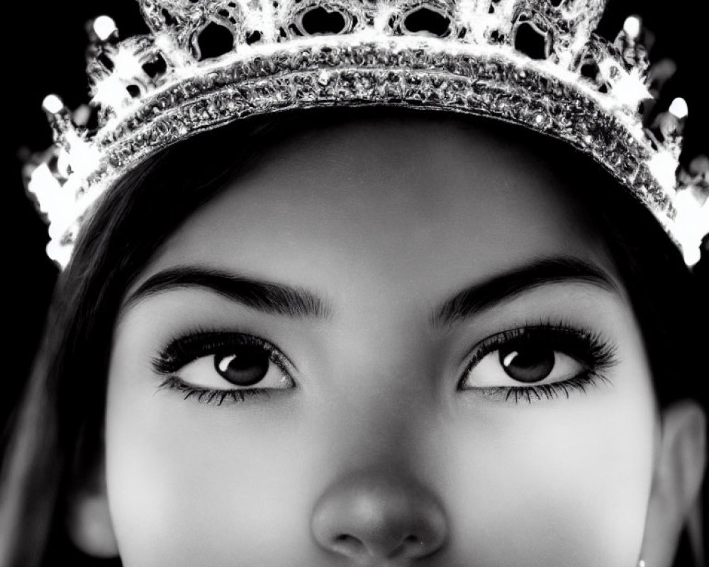 Sparkling crown worn by a person, close-up shot against dark background