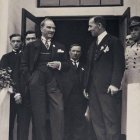 Vintage black and white photo of four men in discussion