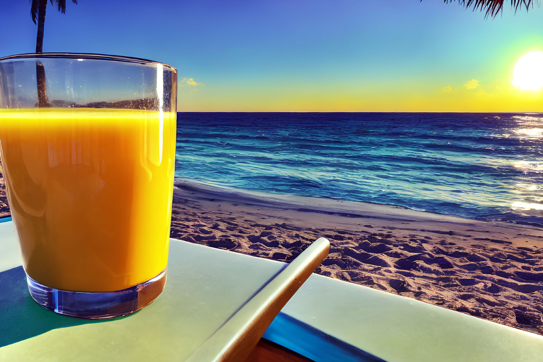 Refreshing orange juice on table by serene beach at sunset