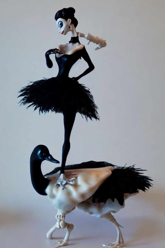 Slender character figurine in black tutu on swan - Detailed description