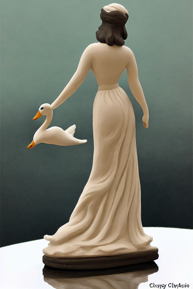 Classical female statue holding swan in flowing gown