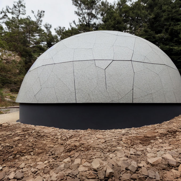 Textured gray dome on black base in rocky terrain with trees - Detailed Description