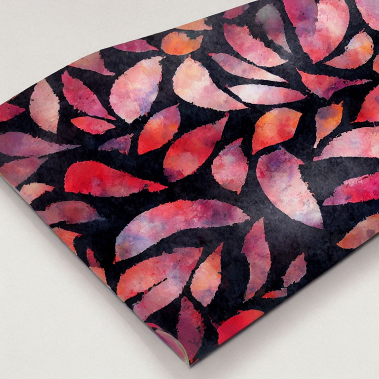 Abstract watercolor design of overlapping pink, red, and purple leaves