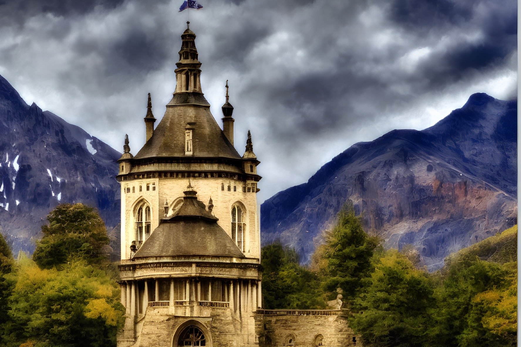 Historic stone tower with spire against dramatic mountain backdrop