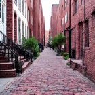 Cobbled Street Painting with Red Brick Buildings and 19th-Century Figures