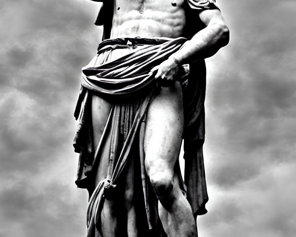 Monochrome photo of muscular bearded statue against dramatic sky