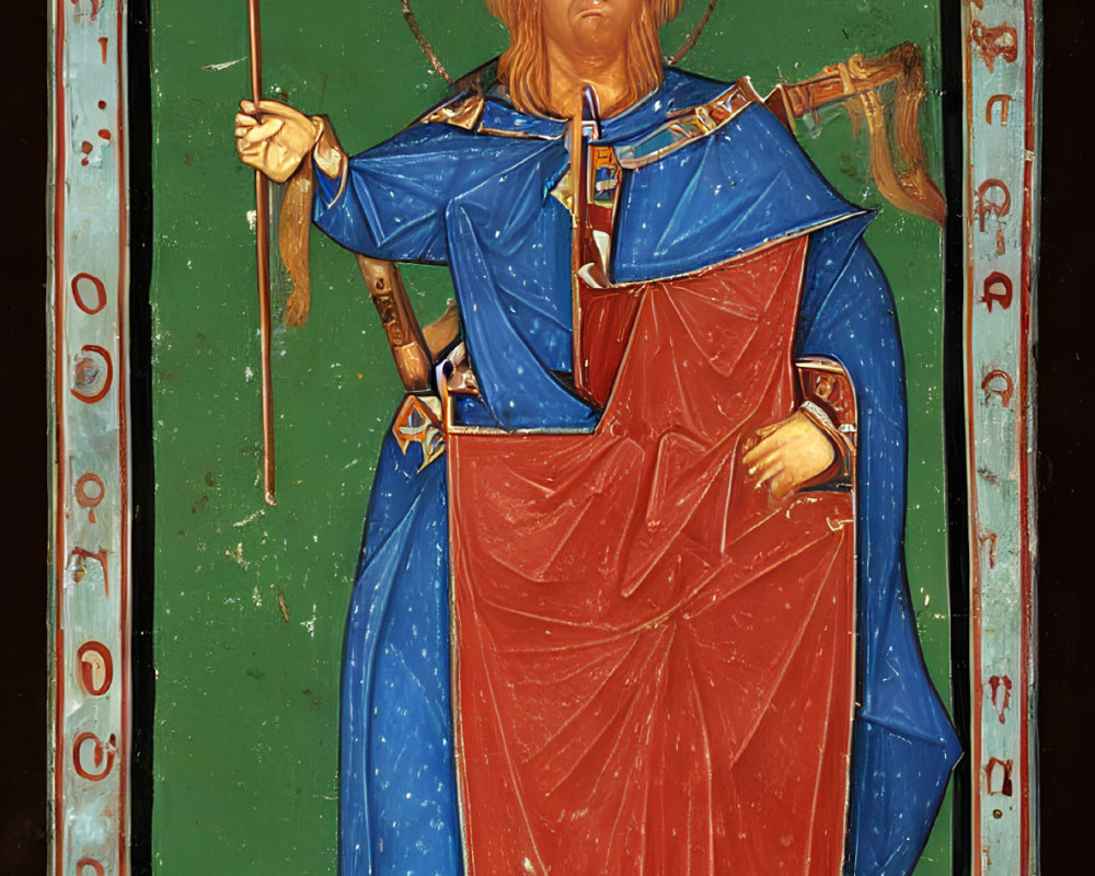 Religious icon with haloed figure in red and blue robes and cross on dark background