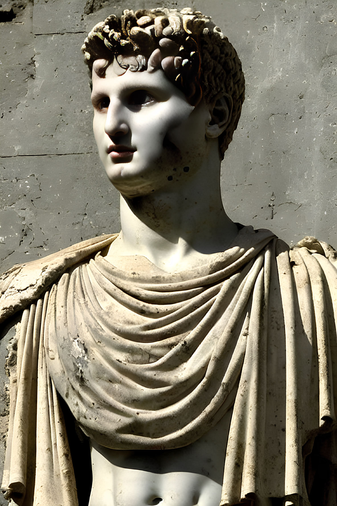 Detailed marble statue of a youthful male figure in classical clothing