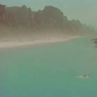 Turquoise waters and cliffs frame a busy beach scene