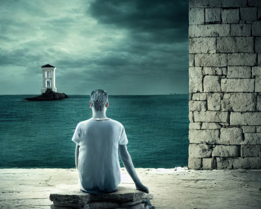 Man sitting by sea looking at distant lighthouse under stormy skies