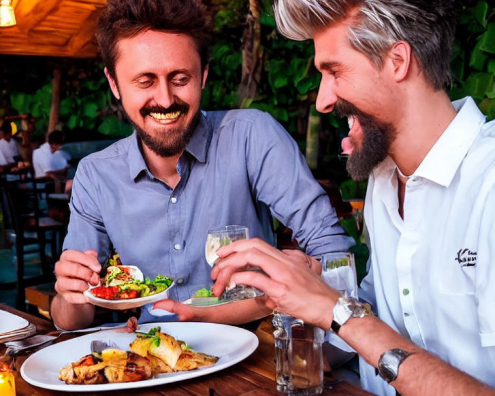 Two Men Smiling at Restaurant with Greenery Background