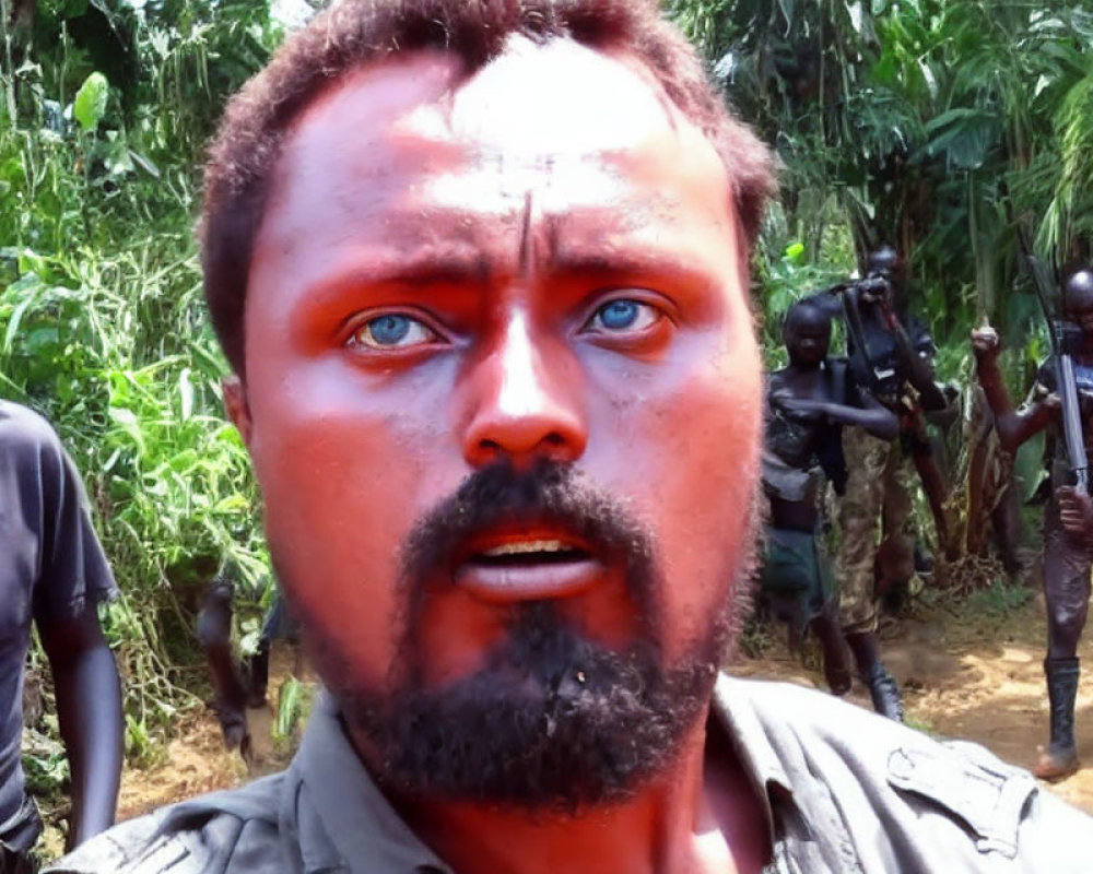 Blue-eyed man with face paint shocked by armed individuals in forest setting