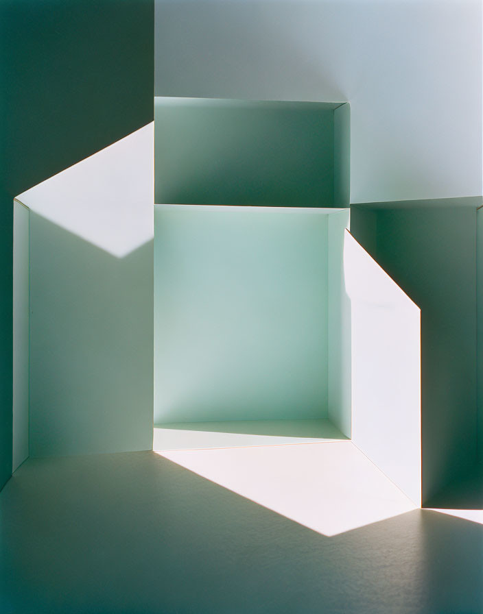 Geometric shapes casting shadows in bright architectural model.