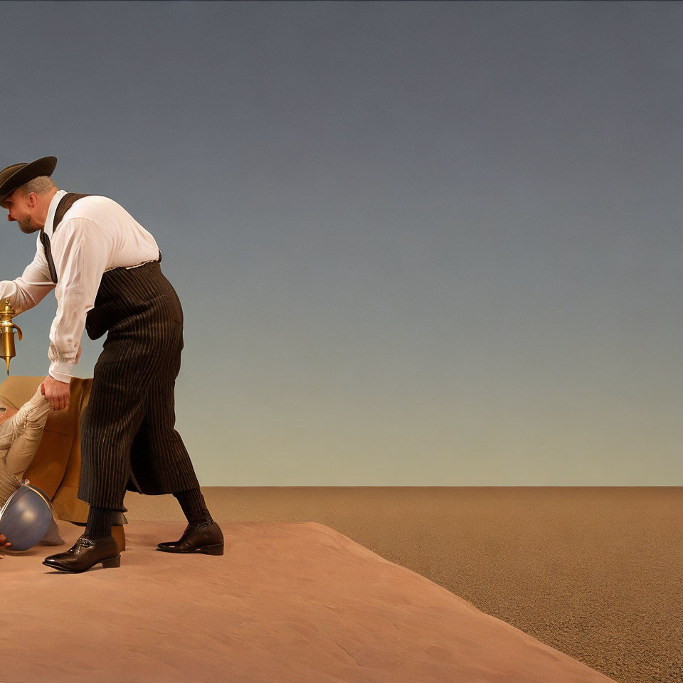 Vintage-dressed man pushing metal ball up sandy hill under clear sky