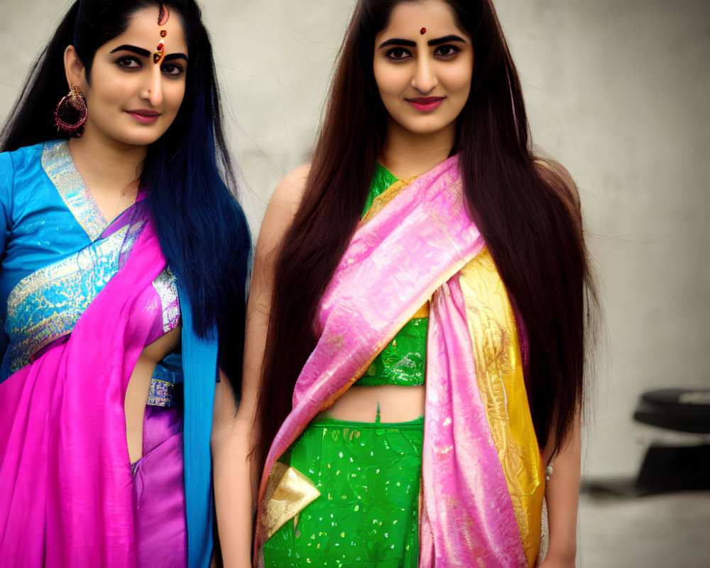 Traditional Indian Attire: Two Women with Long Hair and Bindis posing for a Photo