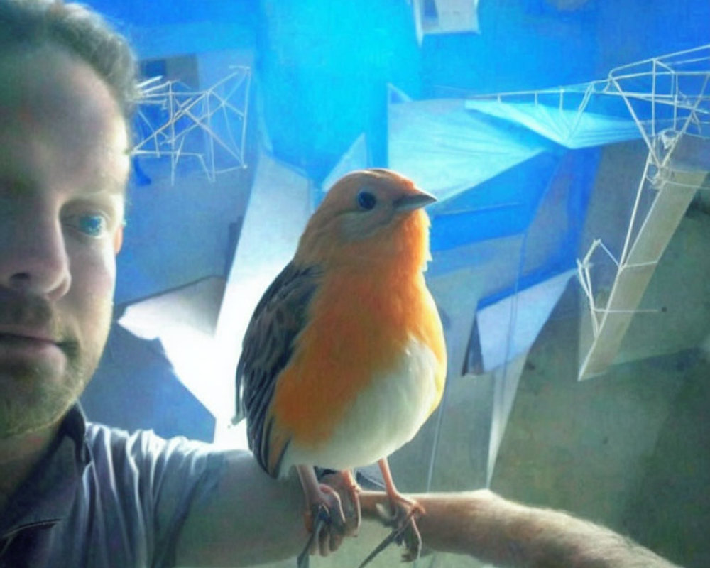 Man taking close-up selfie with vibrant orange-breasted bird indoors.