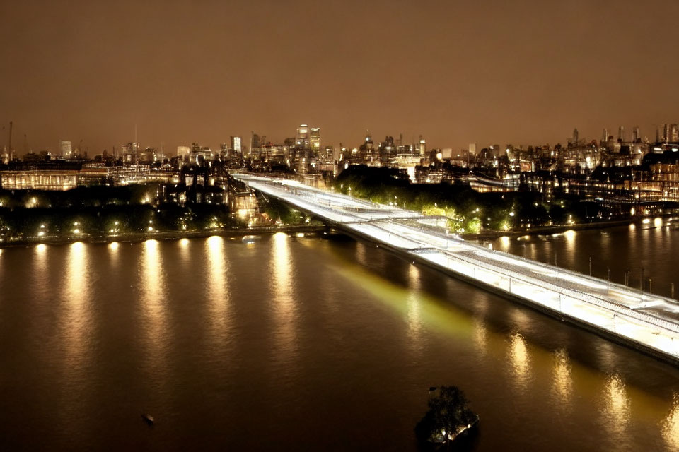 Brightly Lit Bridge Over River with City Lights at Night