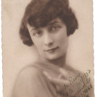 Portrait of young girl in vintage attire with floral hat and forlorn expression