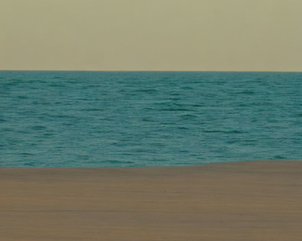 Tranquil Beach Scene with Blue Waters and Sandy Shore