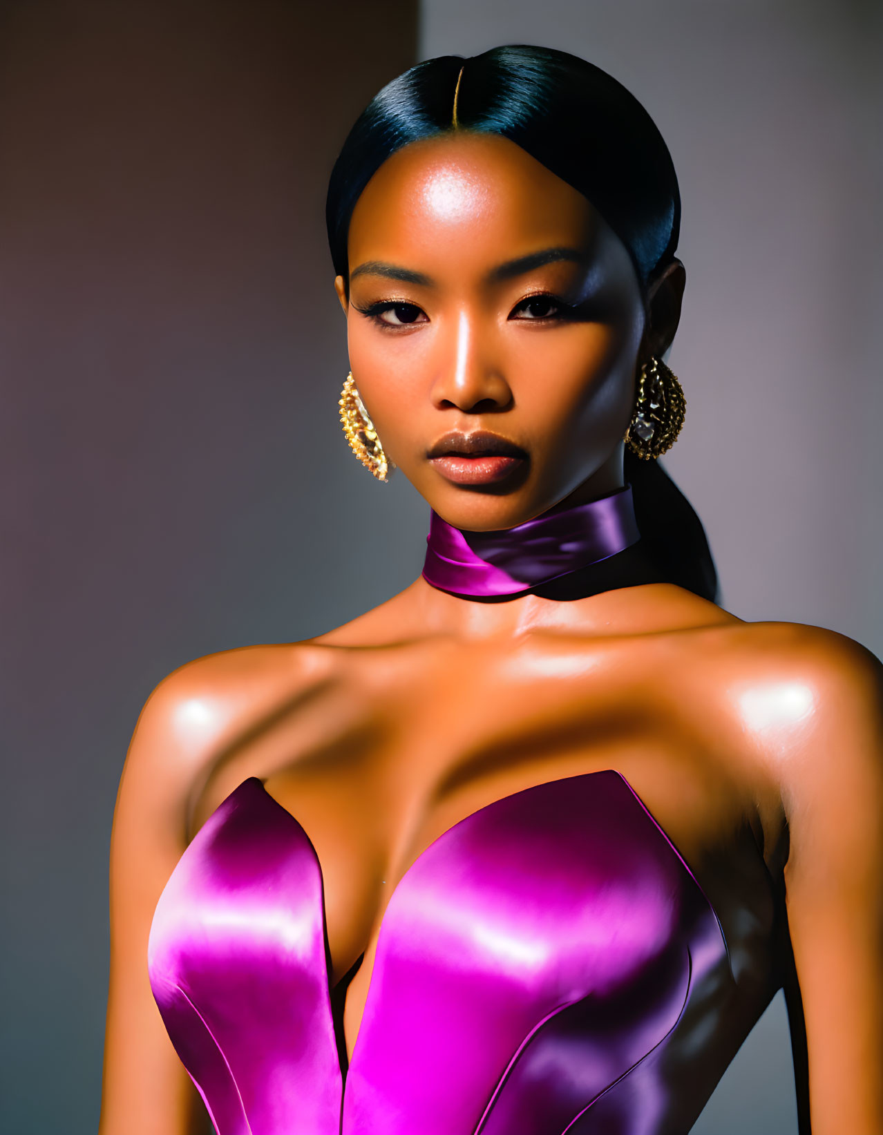 Striking makeup and sleek hair on woman in purple dress pose