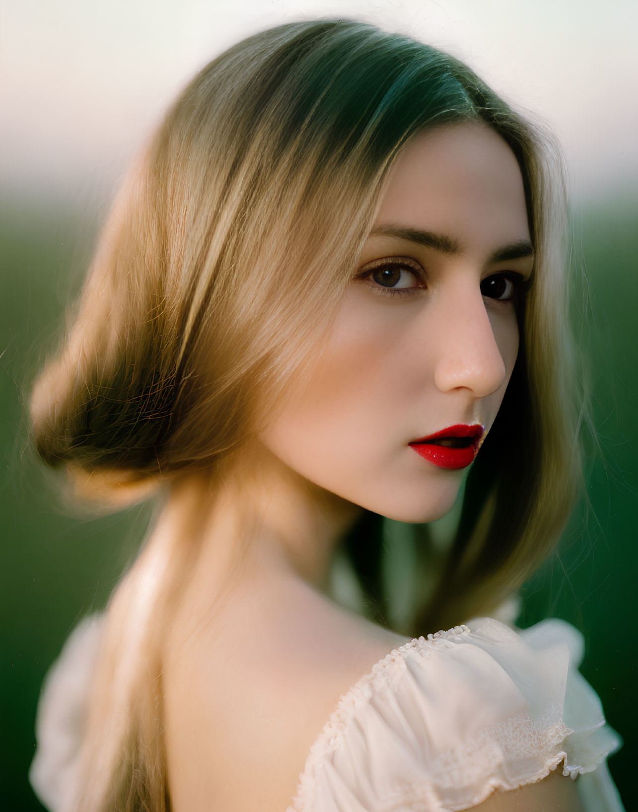 Blonde woman portrait with serious expression and red lipstick