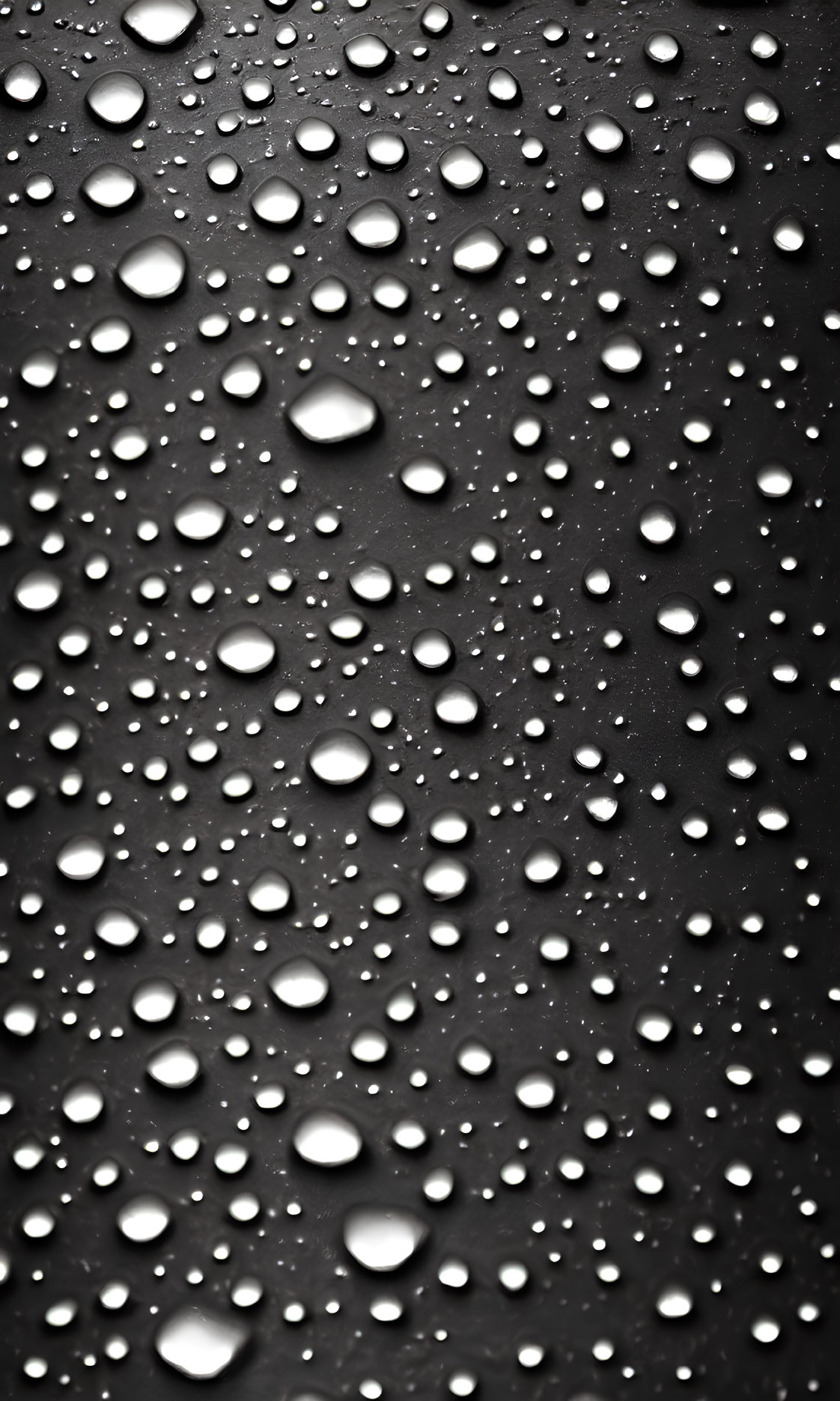 Monochrome image: Water droplets on reflective surface