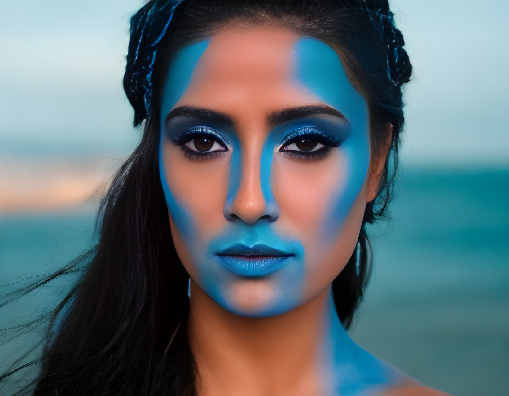 Striking Blue Makeup and Braided Hair on Woman at Beach