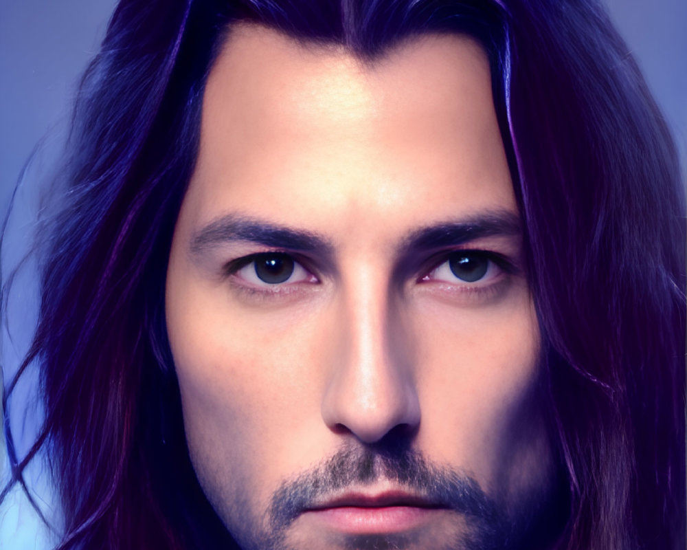 Portrait of man with medium-length dark hair, slight beard, intense eyes on violet gradient.