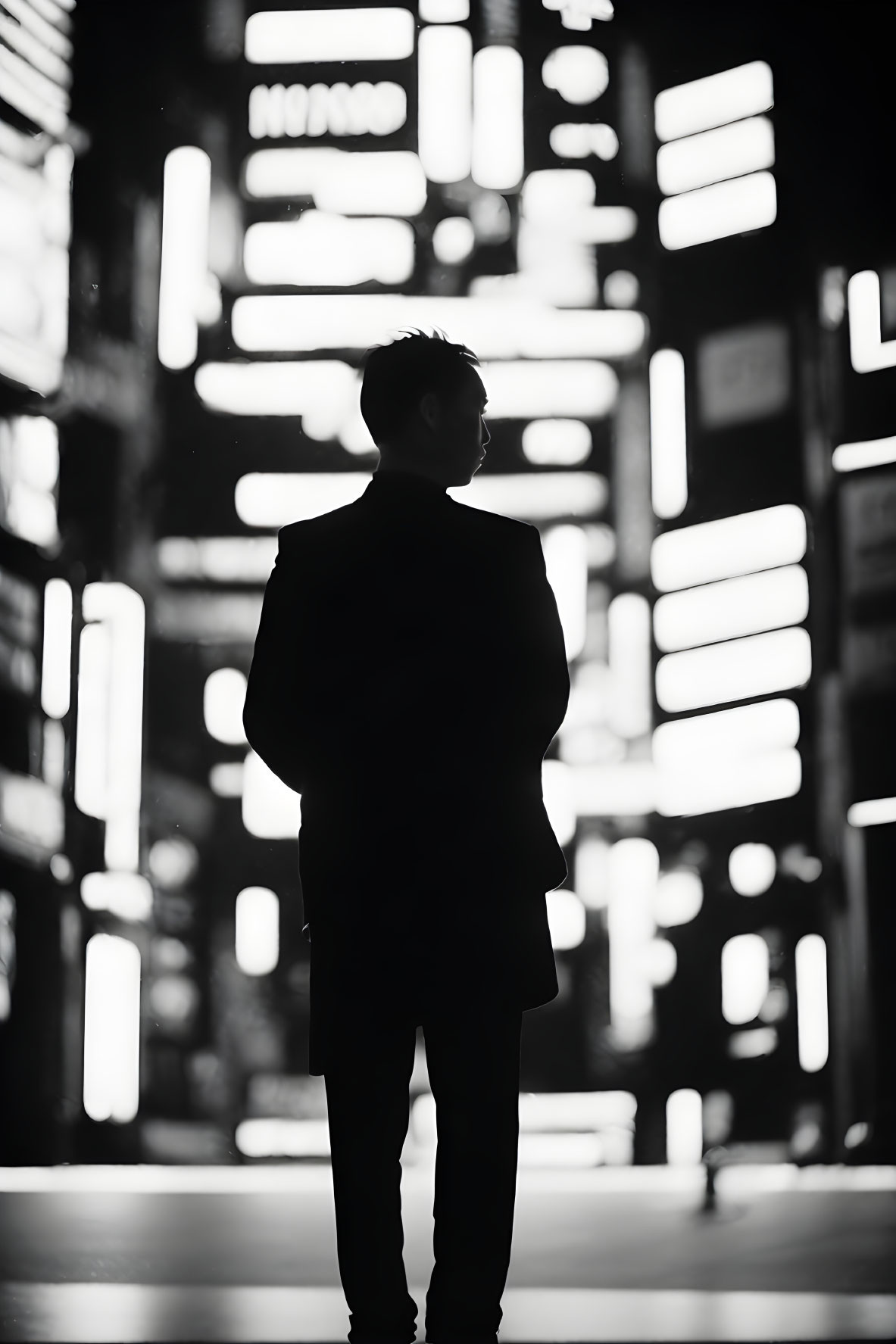 Silhouette of a person against bright vertical neon lights