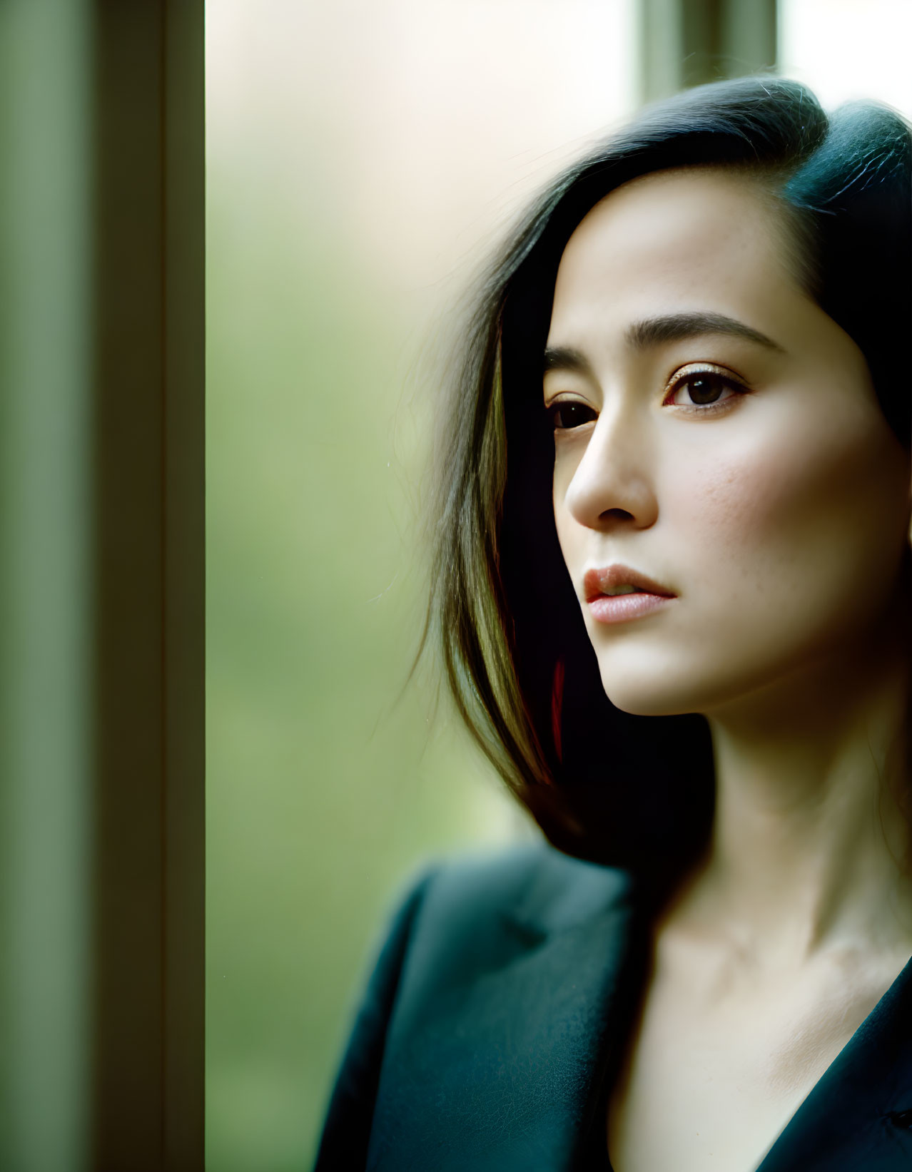 Profile of a Woman Gazing Out Window in Soft Light