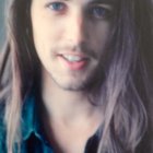 Portrait of a man with blue eyes, long hair, mustache, and goatee