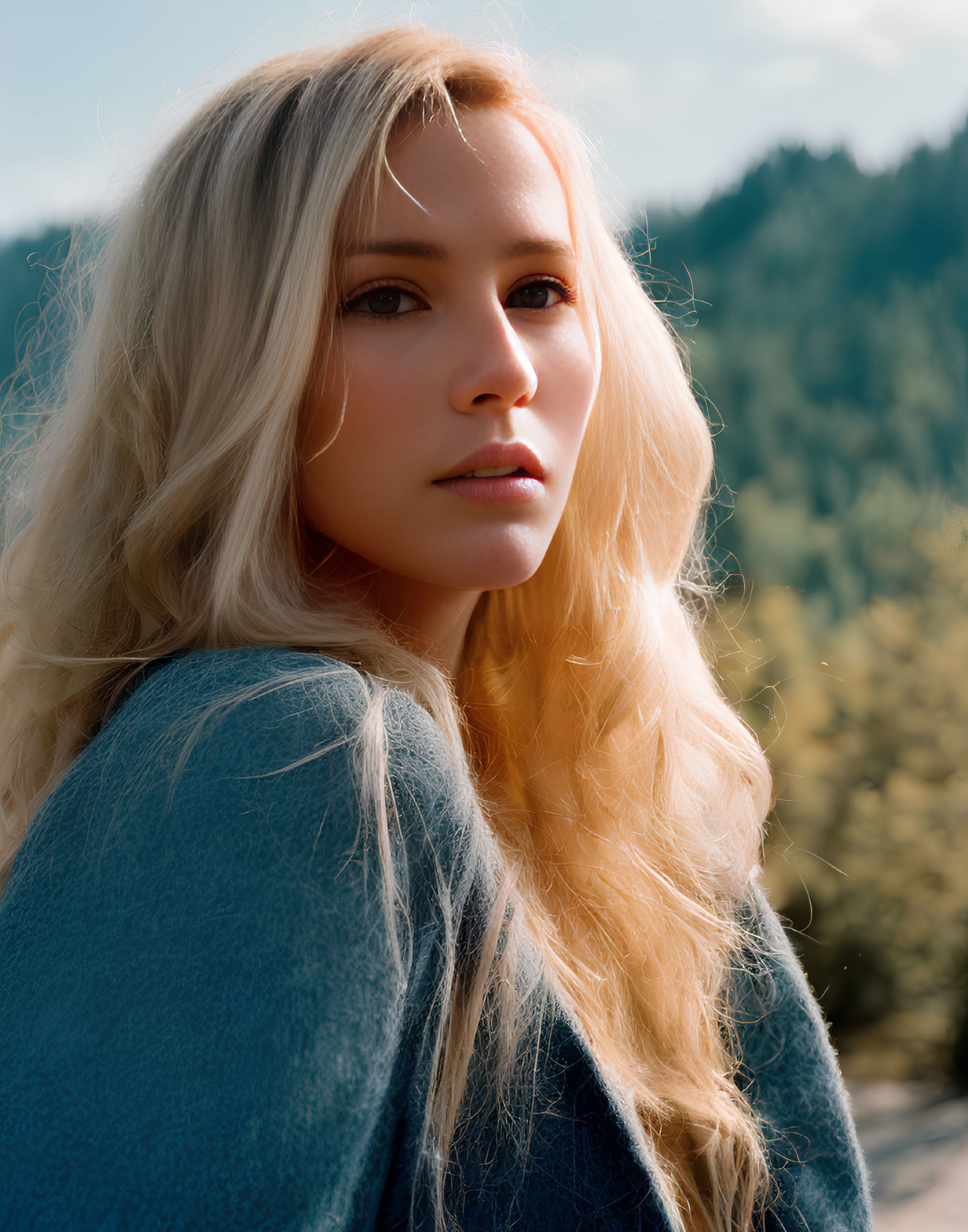 Blonde Woman Portrait in Blue Top with Thoughtful Expression