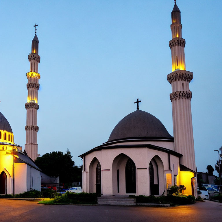 Twilight mosque with illuminated minarets and dome