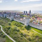 Majestic cityscape with castles, flags, and golden sunlight