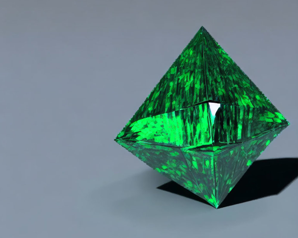 Green Glass Octahedron Reflects Light on Gray Background