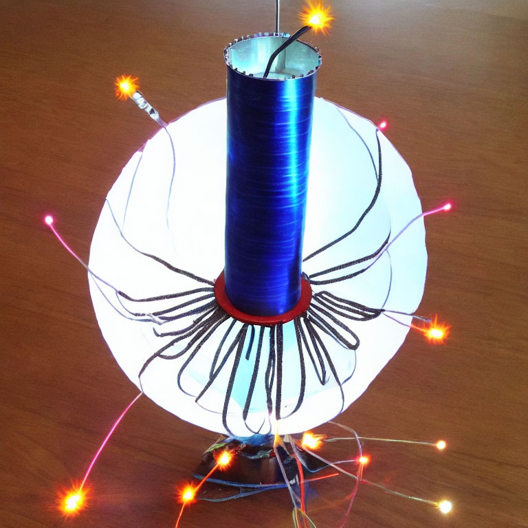 Blue Winding Tesla Coil Emitting Orange and White Sparkles