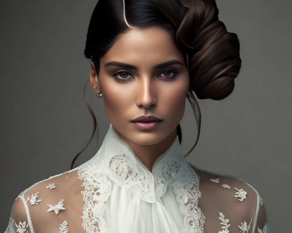 Elegant woman in white lace dress with updo hairstyle