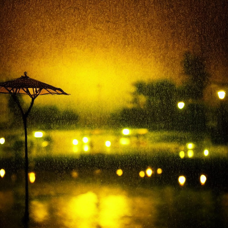 Silhouette of umbrella-like structure with glowing lights and raindrops on window