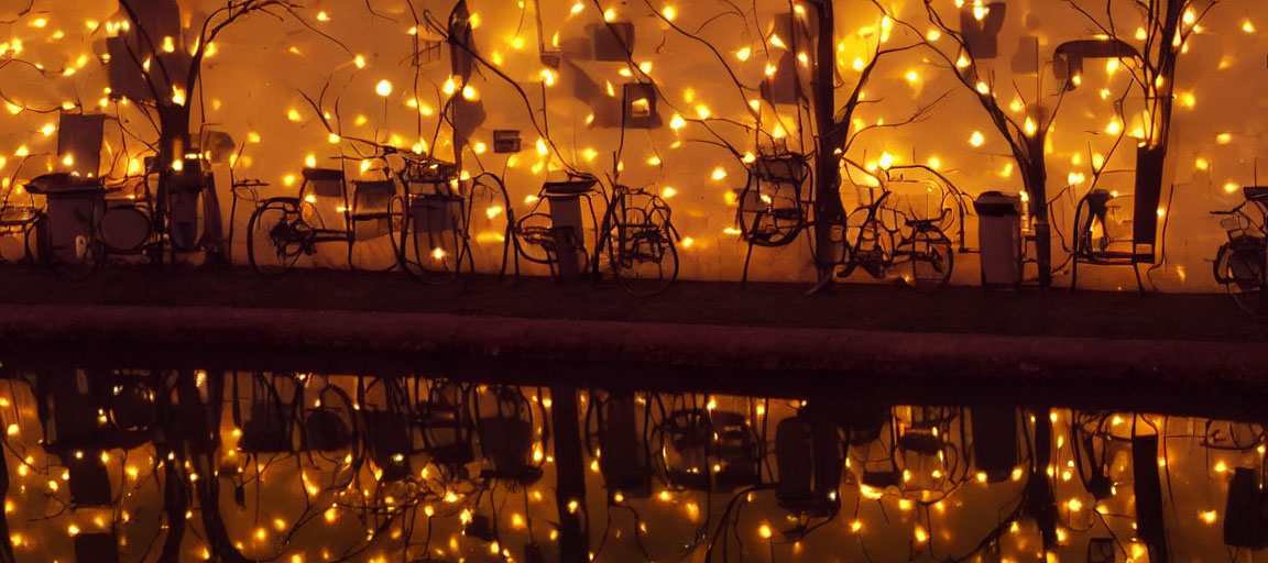 Bicycles with Fairy Lights Reflecting on Water Surface at Night