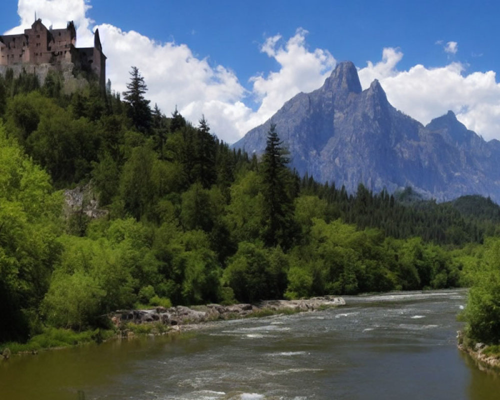 Historic castle on hilltop with river, mountain, and lush greenery