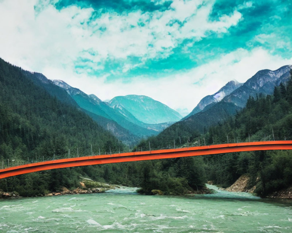 Red bridge over turbulent river in lush forest and mountains under cloudy sky