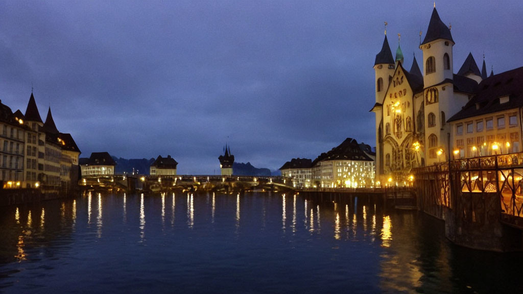 Cityscape: Calm River, Illuminated Buildings, Church with Twin Towers, Covered Bridge