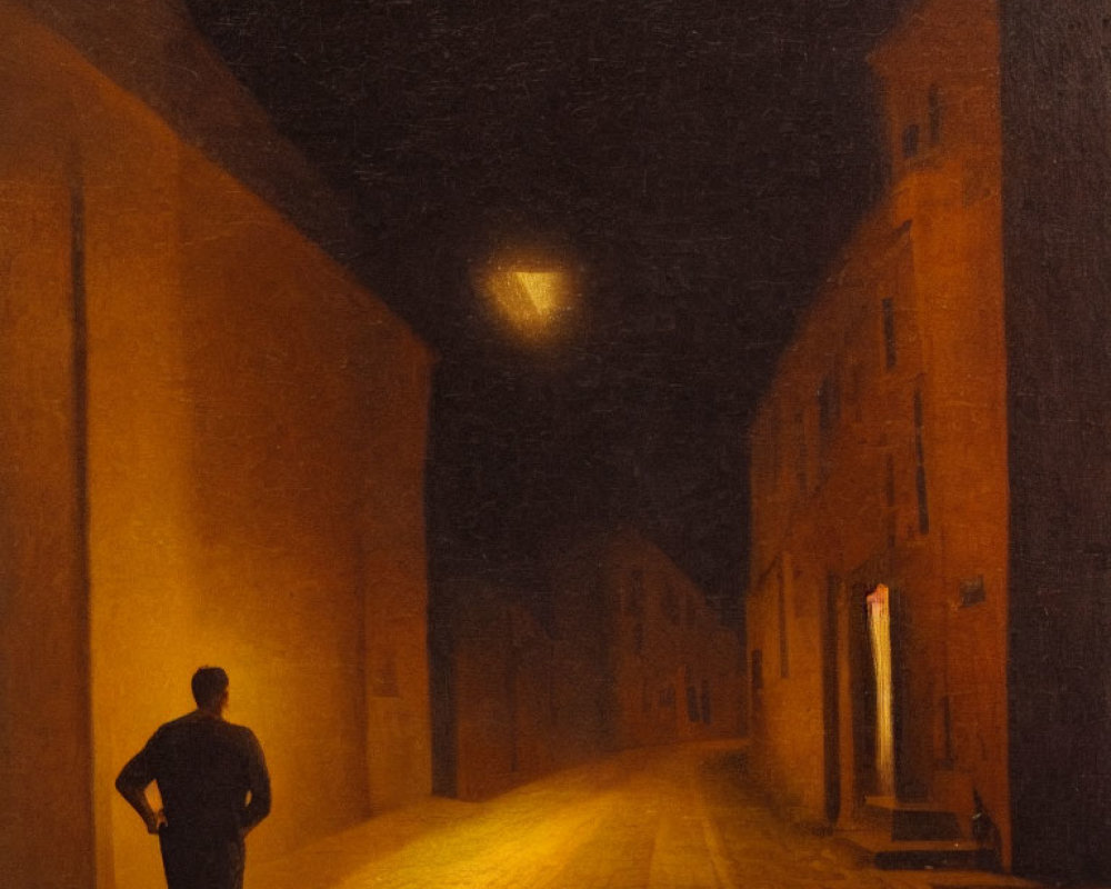 Solitary figure in dimly lit cobblestone street at night