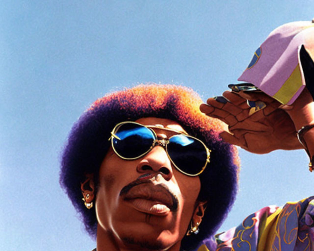 Man with Afro and sunglasses casting shadow, looking up against blue sky