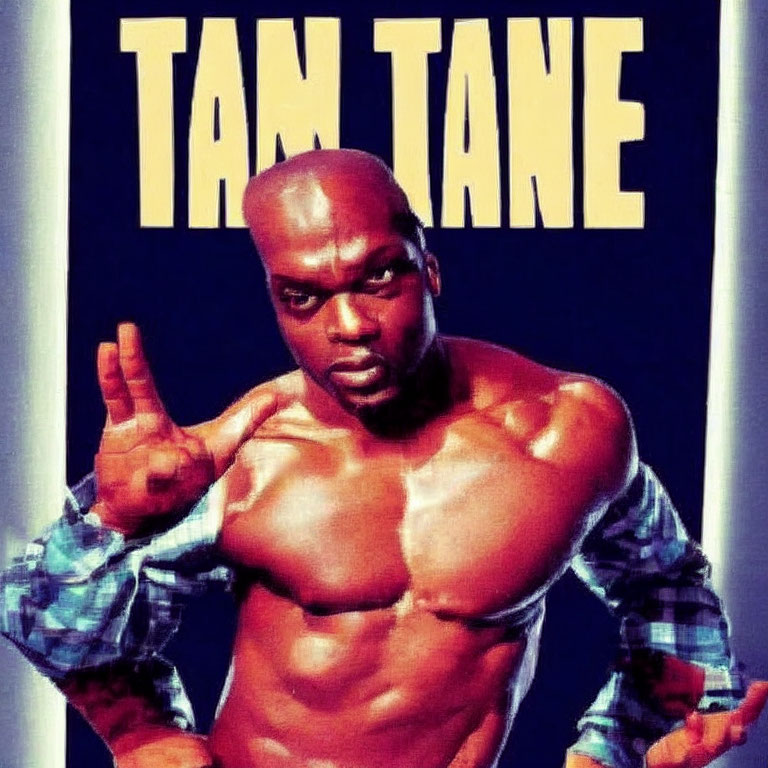 Muscular person in checked shirt sleeves pointing upwards with "TAM TANE" text above