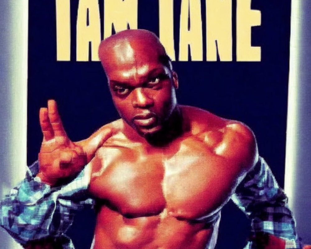 Muscular person in checked shirt sleeves pointing upwards with "TAM TANE" text above